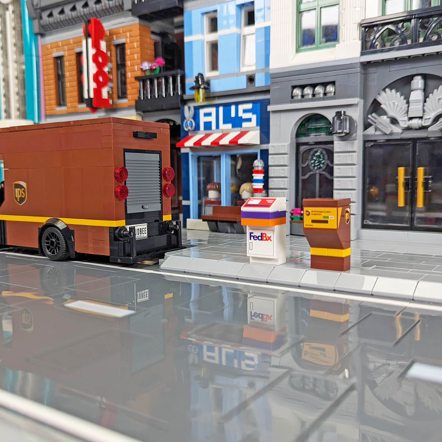 Toy IPS truck with IPS and FedBx drop boxes in a brick built city and sidewalks